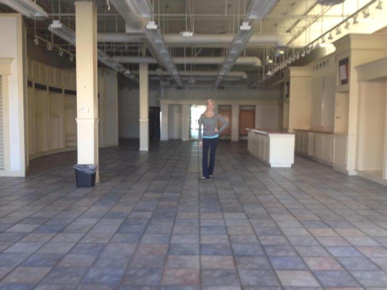 Owner of Allie Ollie Allie Olson Standing in Empty Boutique Space